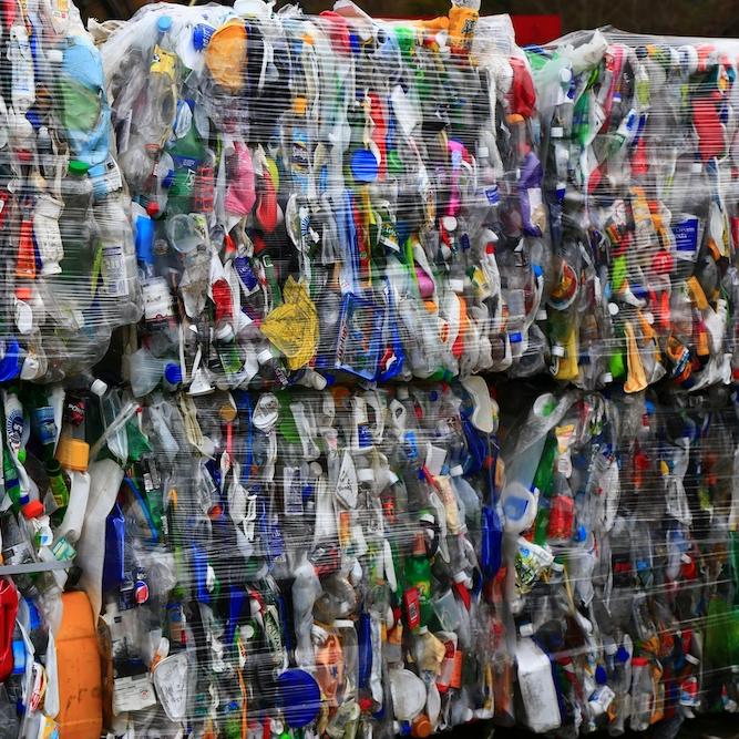 		Plastic items in many colors crushed together and wrapped for recycling
	