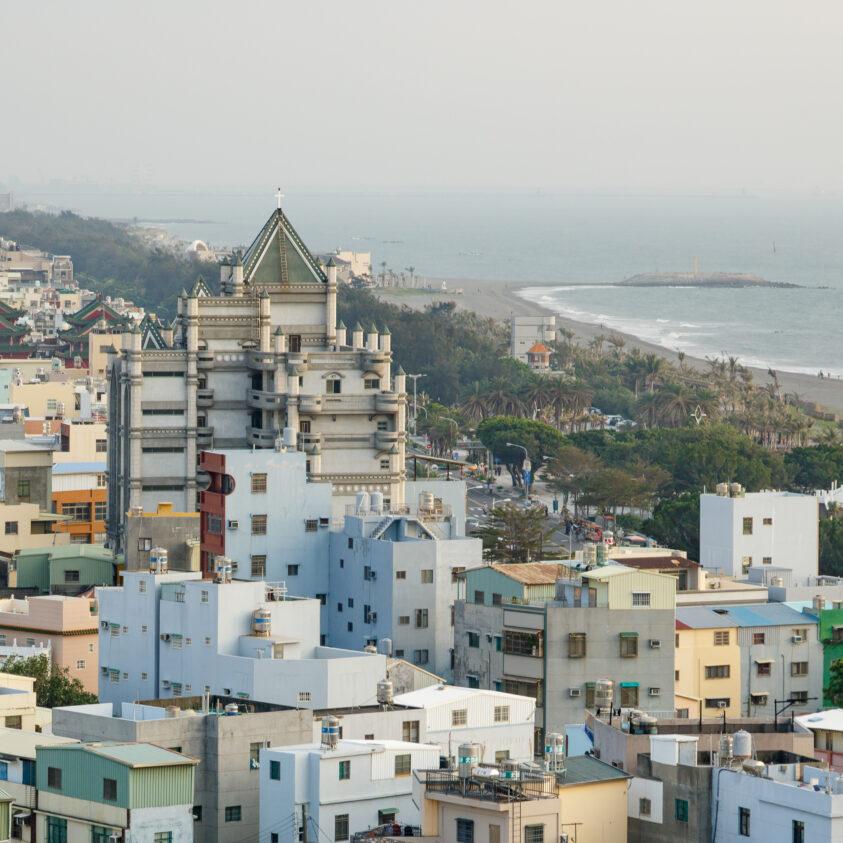 A city near a coastline; cloudy sky