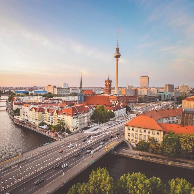 View of a city (Berlin) from above: river and red-roofed buildings