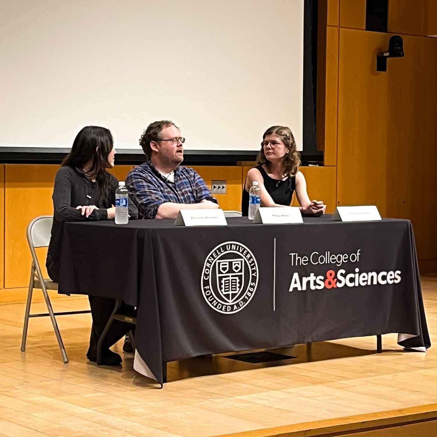 		three people at a table
	