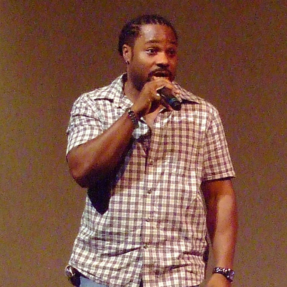 		Person speaking into a microphone
	