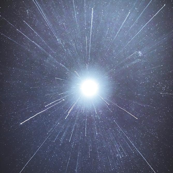 White spark of light against a blue-black background