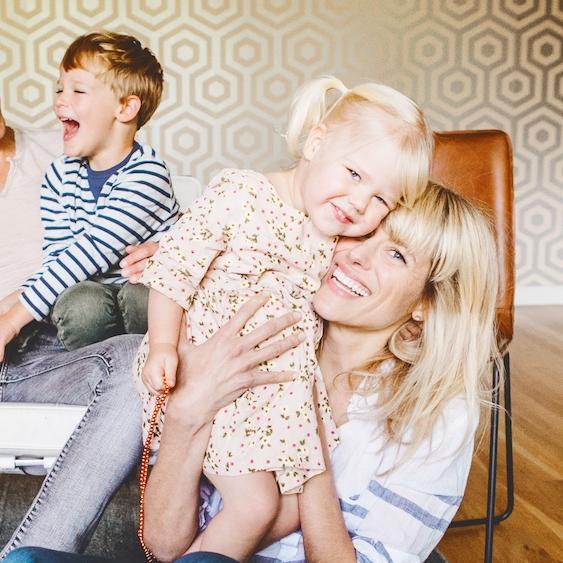 Family of five on and in front of a couch