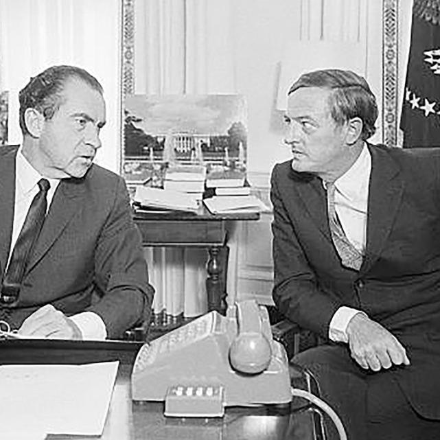 		Historic photo of two men in suits at a desk, conferring: Richard Nixon and William F. Buckley
	