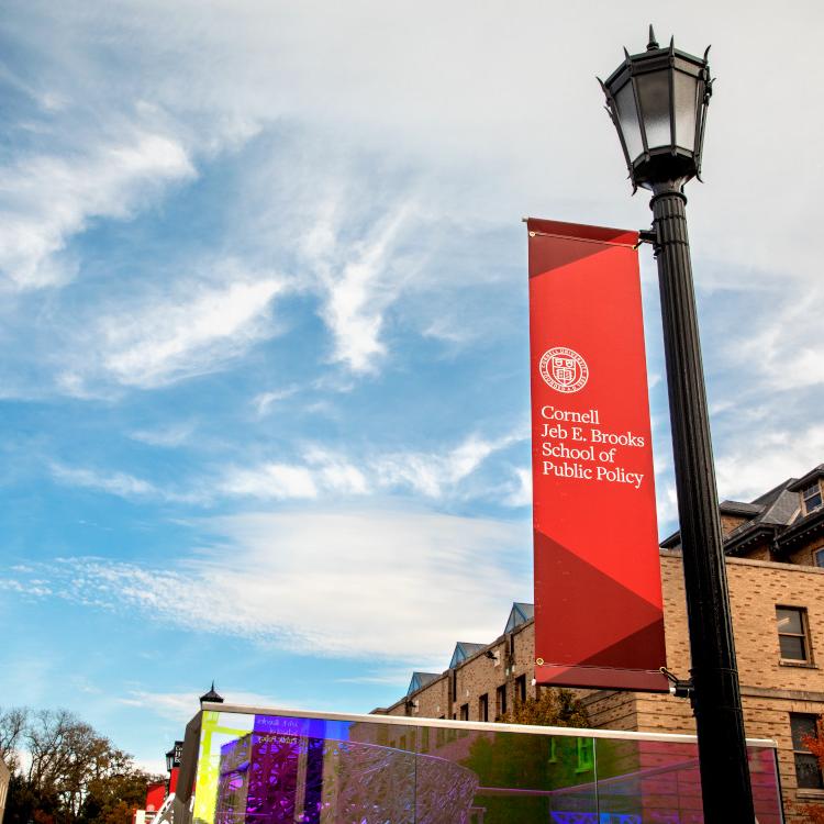 		Lamp post with a red banner attached: Cornell Jeb E. Brooks School of Public Policy
	