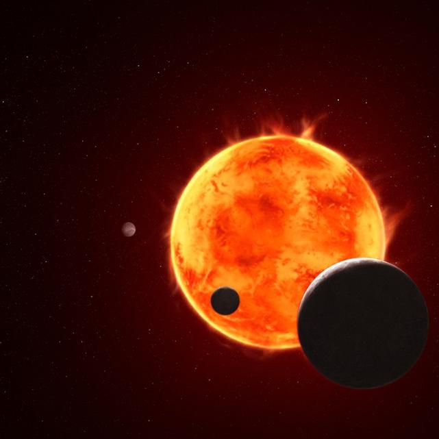 		An orange-yellow sun with spheres of exoplanets silhouetted against it.
	