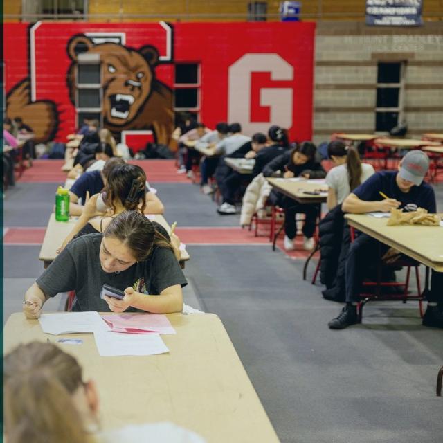 promotional image showing three faculty head shots and a picture of students taking an exam in a very large hall