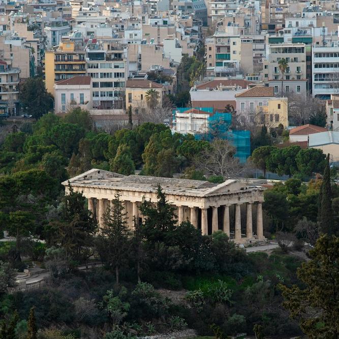 		Ancient stone building near modern buildings in Athens, Greece
	