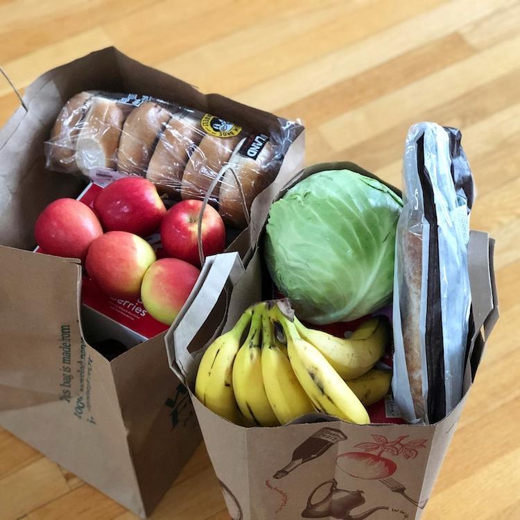 two brown paper bags full of groceries