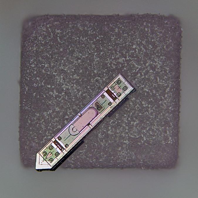 Grey square topped by a silver arrow-shaped object