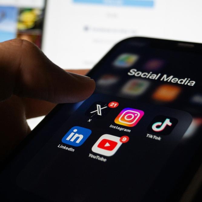 		phone with dark mode screen and social media icons
	