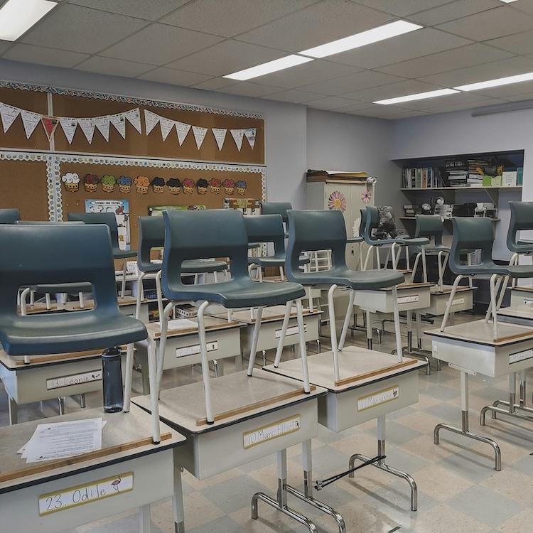 		A classroom empty of students; the chairs are on desks
	