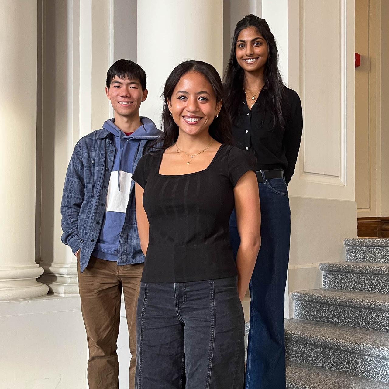 		three people smiling
	