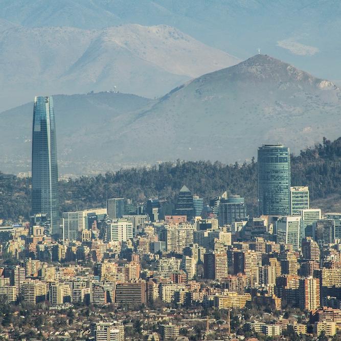 looking down on a large city set among mountains