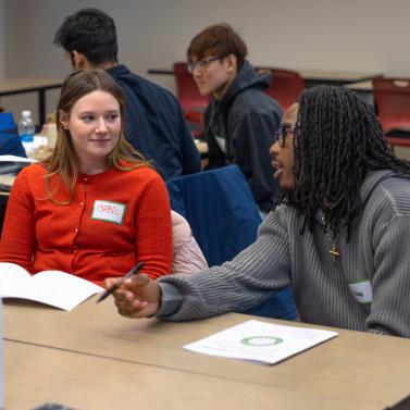 		Students sit at tables, discussion together
	