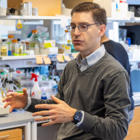 		Person talking with lab equipment in the background
	