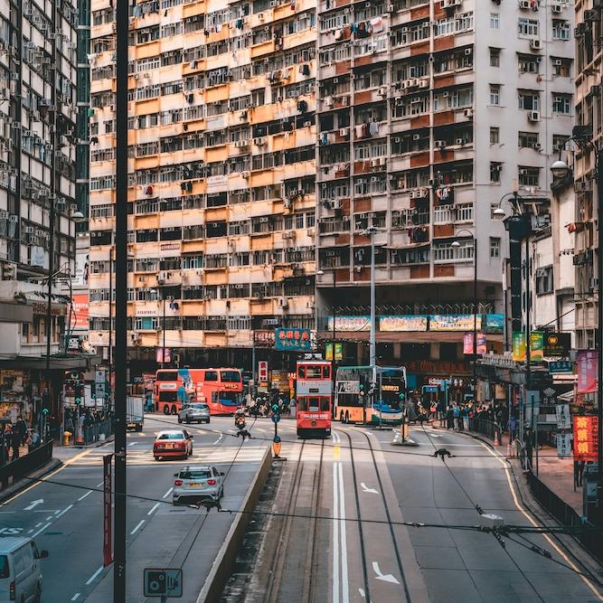 		High rise apartment building fronting a city street with a trolley
	