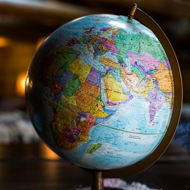 		desktop globe model in a dimly lit room
	