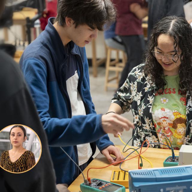 Two students connecting wires on a lab table