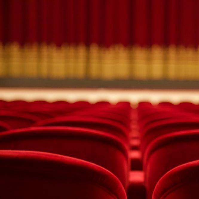 		Theater seats and a curtain in the distance
	