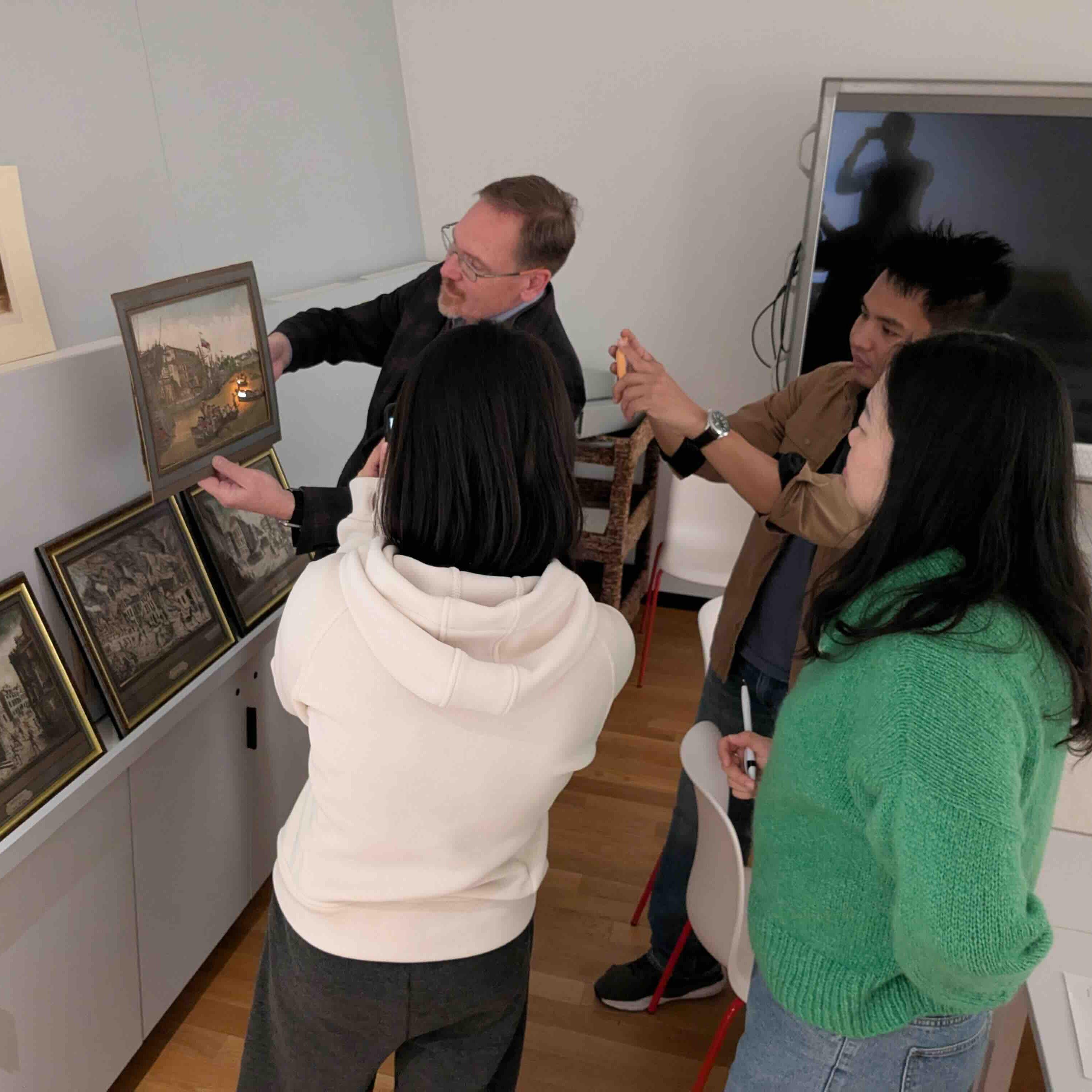 people standing around a portrait