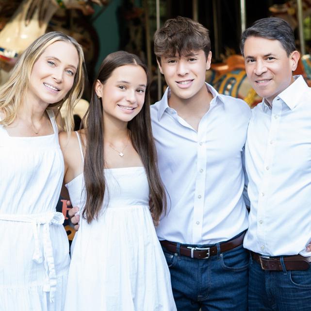 		A family of four in a posed picture
	