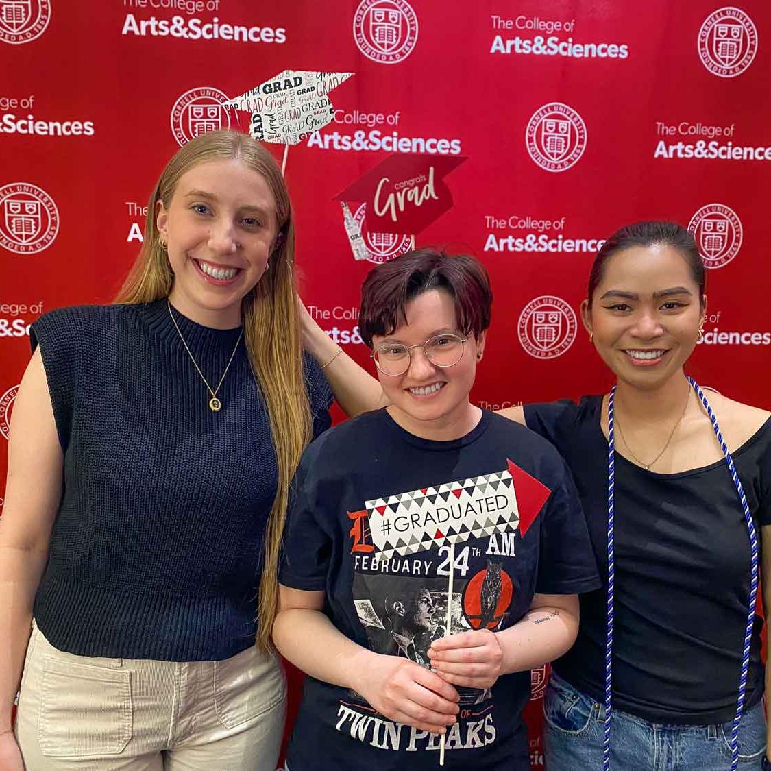 three people standing with signs