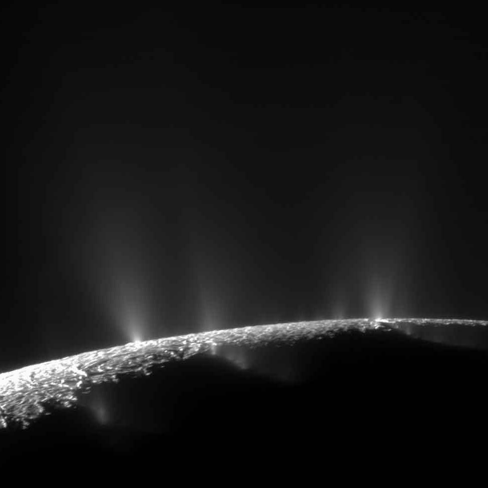The horizon of Enceladus showing water vapor spewing into space.