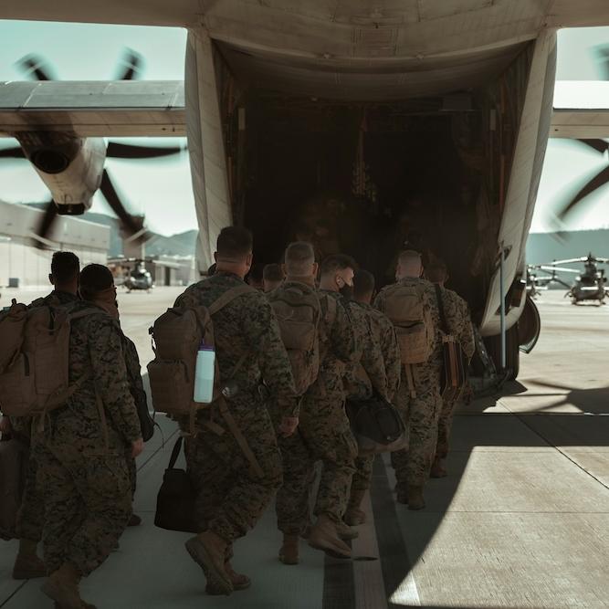 U.S. marines and sailors loading into an aircraft