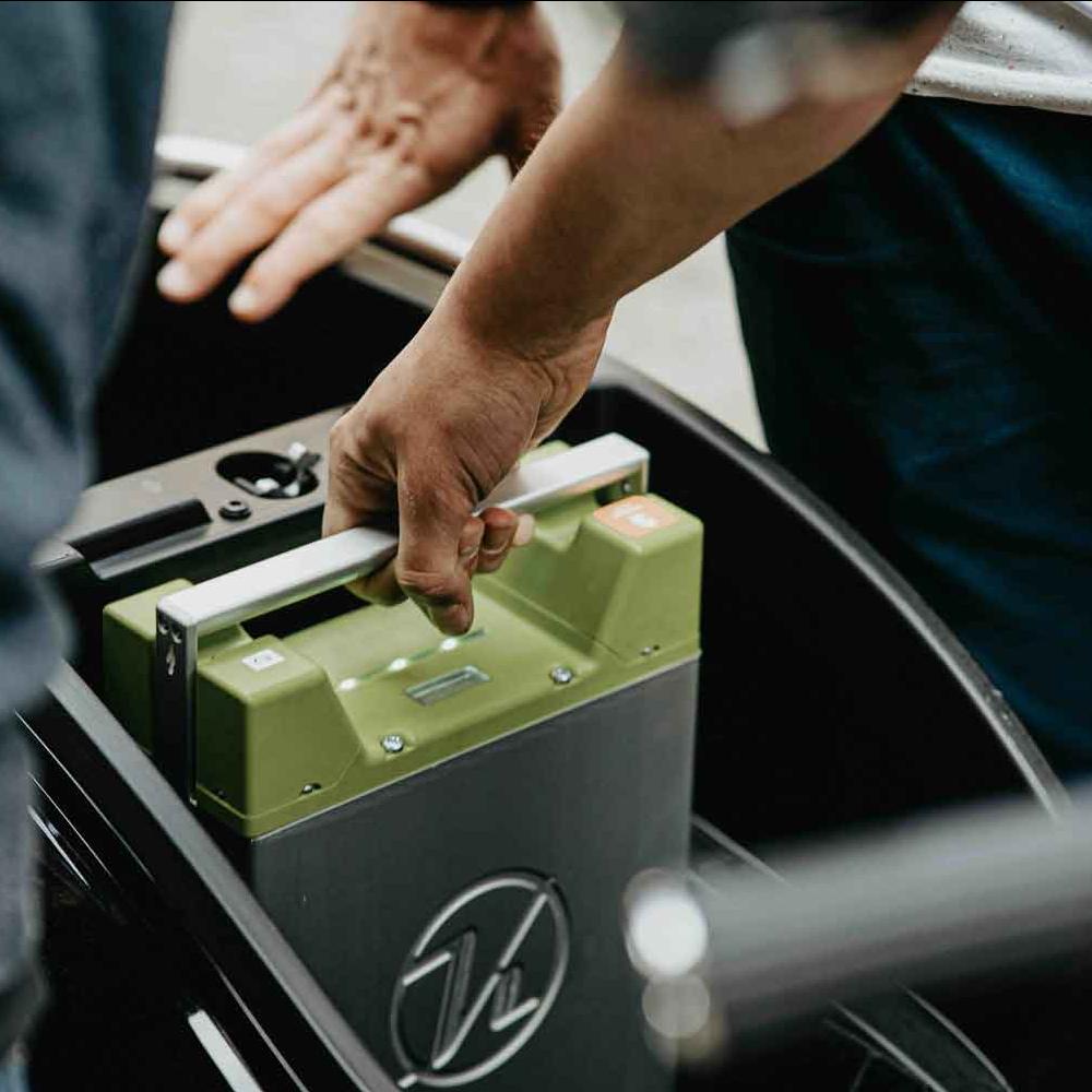 person taking out an electric car battery