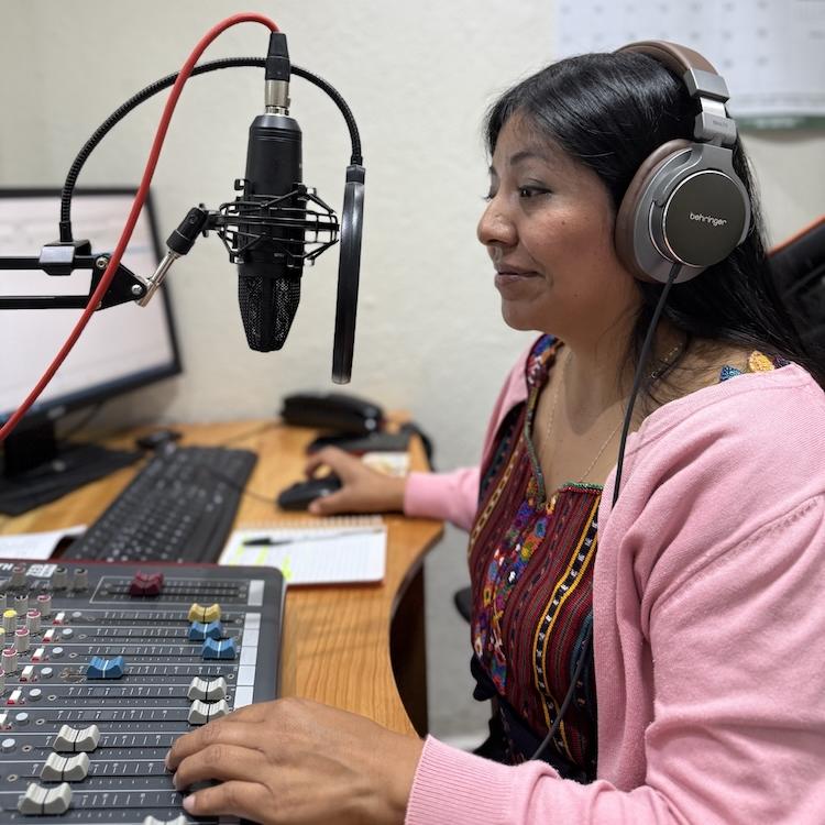 		Person wearing large headphones, speaking into a microphone
	