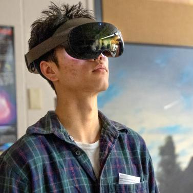 Young man wearing a VR headset looking up toward the ceiling