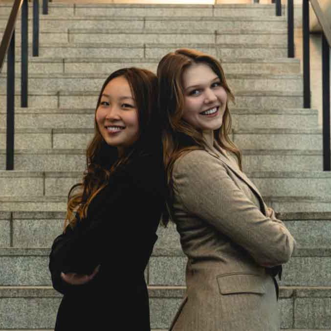 two people in front of a set of stairs