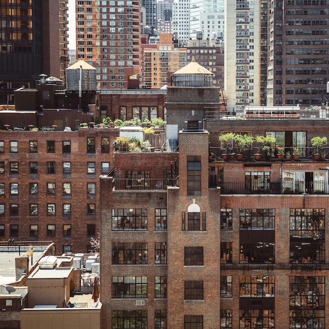 layers of brick and glass buildings in a city