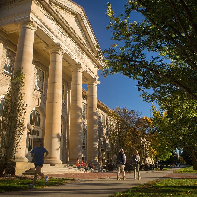  Students walk past Goldwin Smith Hall in the fall