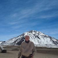 Fred Young ’64, M.Eng. ’66, MBA ’66 in front of the summit of Cerro Chajnantor in the Atacama Desert of northern Chile, site for the Fred Young Submillimeter Telescope.