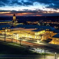 Modern building lit up at dusk, seen from above