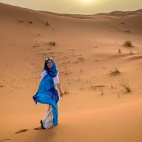 person wearing blue scarf in a desert