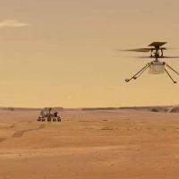 small helicopter flying over a barren, orange landscape