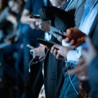 people in business clothes check smart phones