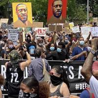 Crowd of people holding signs