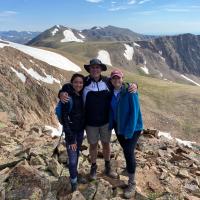 Three people in the mountians