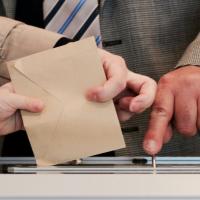 Hands handling a ballot