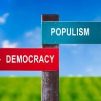 Sign showing Populism going one way and democracy the other