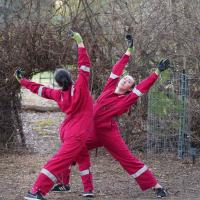 people dancing in red jumpsuits outside