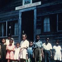  African American children standing in front of the &quot;Fernwood Colored School&quot;