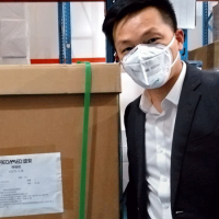  Person in mask by shipping crate