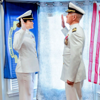  Two people in military uniform, facing each other