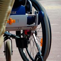  A closeup of the back wheel of a wheelchair