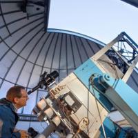  Astronomer looking through telescope